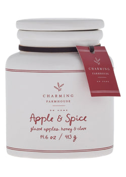 White candle jar with 'Apple & Spice' label and Charming Farmhouse tag on a white background