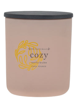 Cream candle with a black lid and gold logo on a cream background