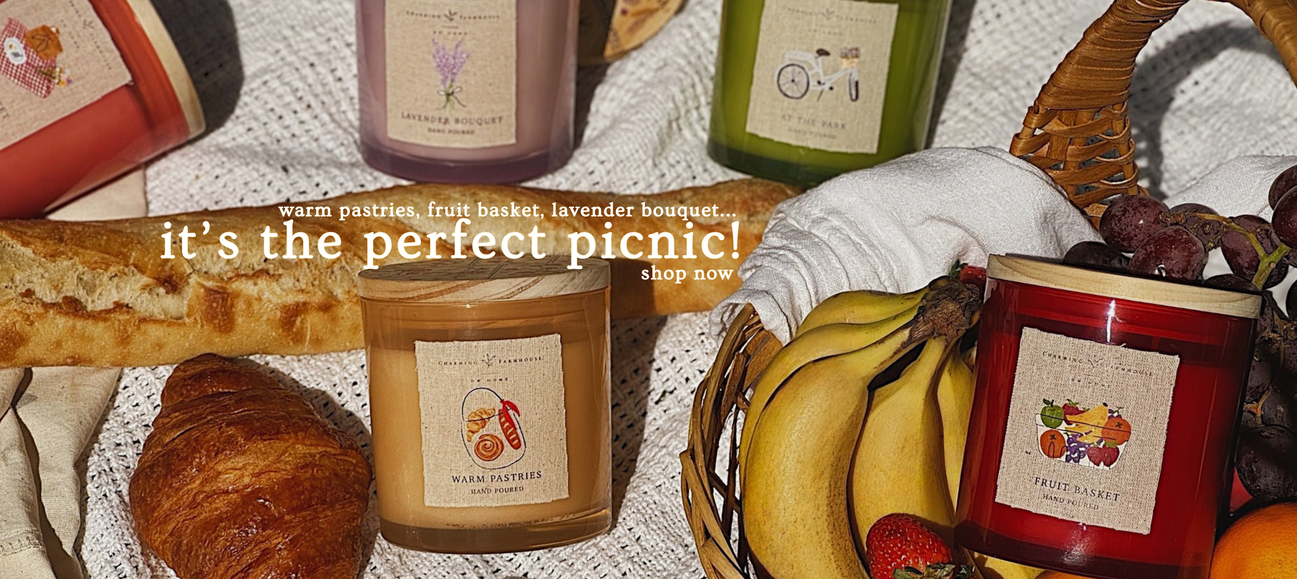 Charming Farmhouse banner image of candles, fruits, and baked goods on a blanket.