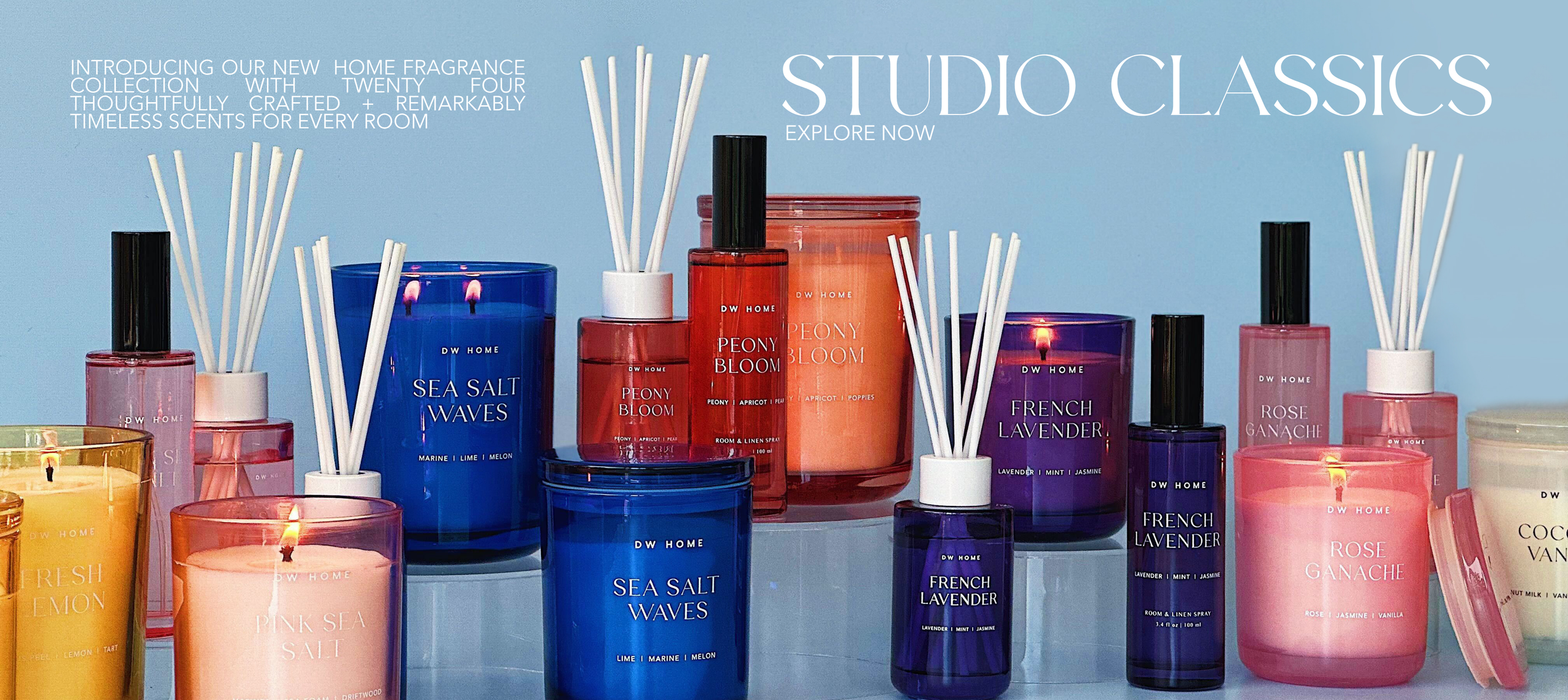 Collection of candles and diffusers with 'Studio Classics' branding on a blue background