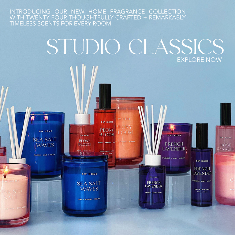 DW Home Studio Classics collection with candles and diffusers on a light blue background