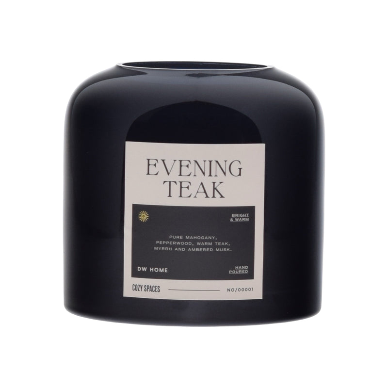 Black candle labeled 'Evening Teak' by DW Home on a white background