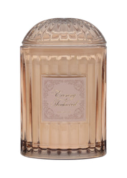 Decorative cylindrical container with a textured lid on a white background