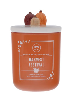 Orange candle labeled 'Harvest Festival' with decorative pumpkin lid