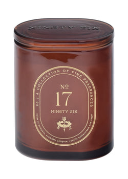 Dark orange candle jar with gold label featuring 'Ninety Six' branding on a dark orange background