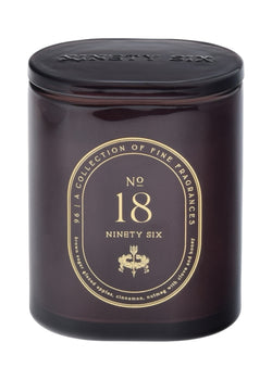 Dark maroon candle with gold text on a maroon background