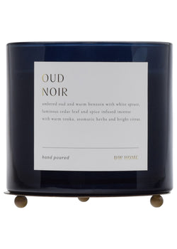 Dark blue candle with a label on a white background