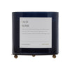Dark blue candle with a label on a white background