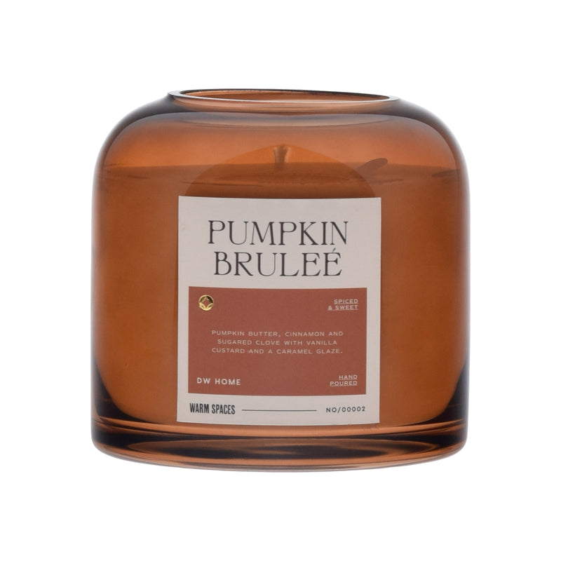 Brown glass candle with 'Pumpkin Brulee' label on a white background