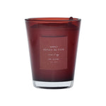 Red candle with a label on a red background
