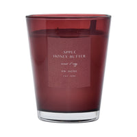 Red candle with a label on a red background