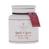 White candle jar with 'Apple & Spice' label and Charming Farmhouse tag on a white background