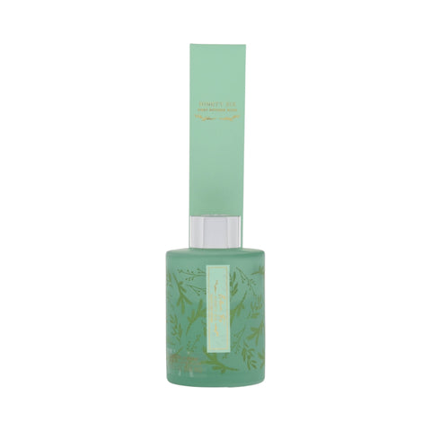 green balsam fir reed diffuser with green reed pack.