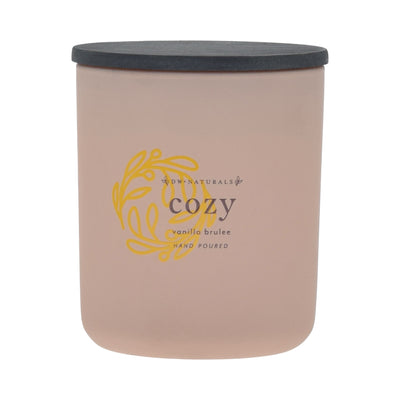 Cream candle with a black lid and gold logo on a cream background