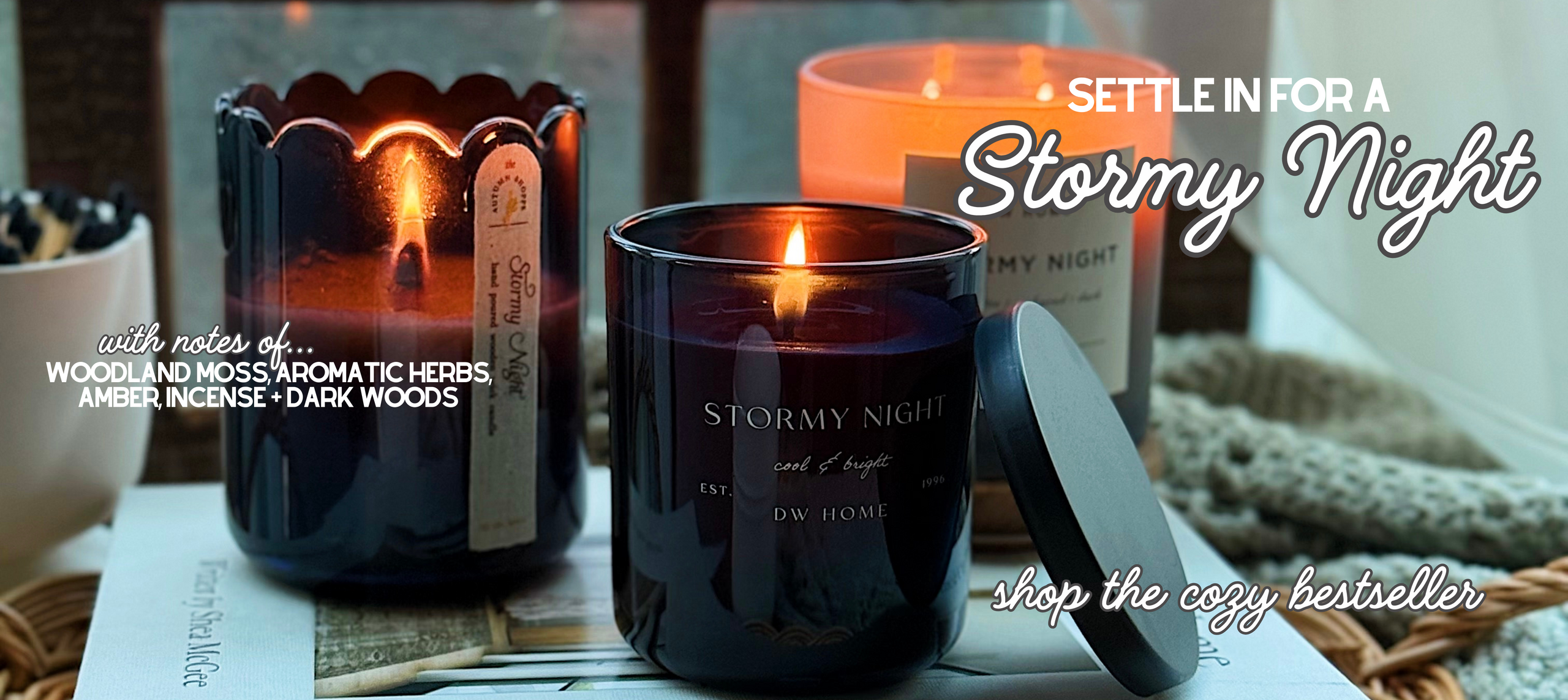 Two lit candles labeled 'Stormy Night' on a table with text promoting a cozy evening.