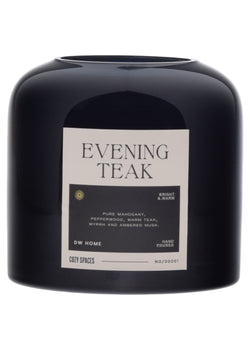 Black candle labeled 'Evening Teak' by DW Home on a white background