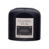 Black candle labeled 'Evening Teak' by DW Home on a white background