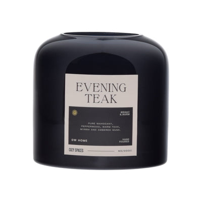 Black candle labeled 'Evening Teak' by DW Home on a white background
