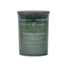 Green candle labeled 'Falling Leaves' by Charming Farmhouse on a green background