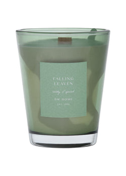Green vase candle with a label on a green background