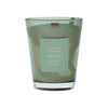 Green vase candle with a label on a green background