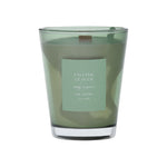 Green vase candle with a label on a green background