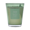 Green vase candle with a label on a green background