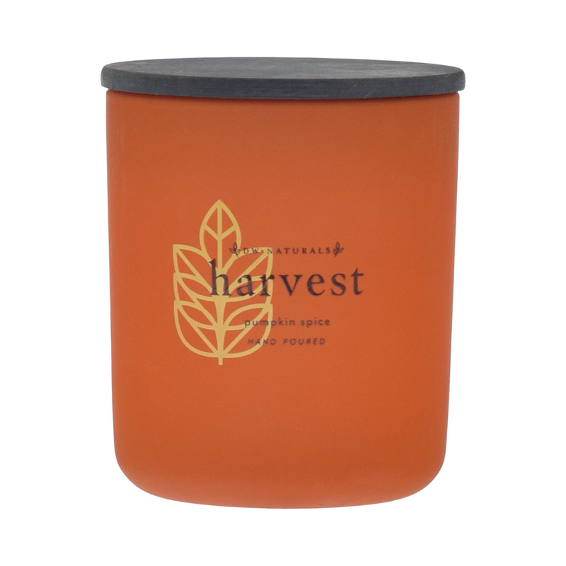 Orange candle with black lid labeled 'harvest pumpkin spice' on an orange background