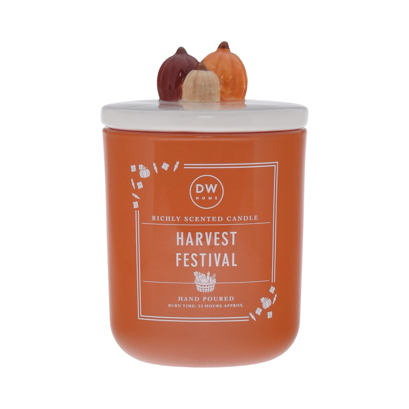 Orange candle labeled 'Harvest Festival' with decorative pumpkin lid