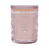 Candle jar labeled 'Heirloom Pumpkin' with a decorative design on a white background