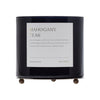 Black candle with a label on a white background