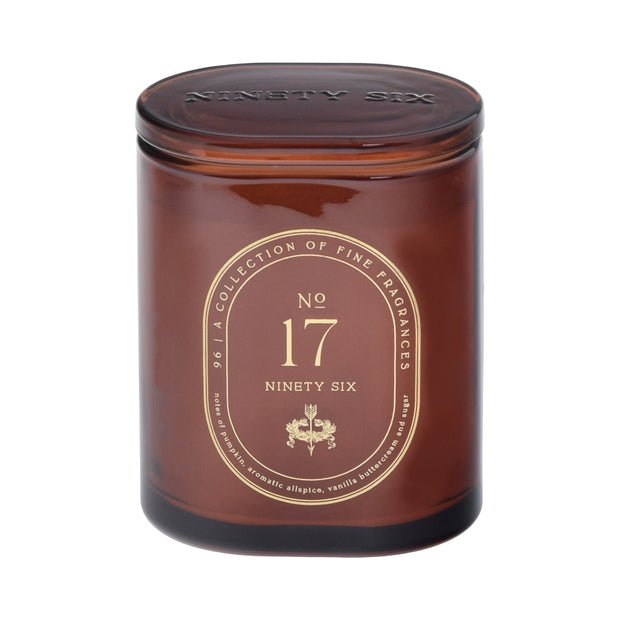 Dark orange candle jar with gold label featuring 'Ninety Six' branding on a dark orange background
