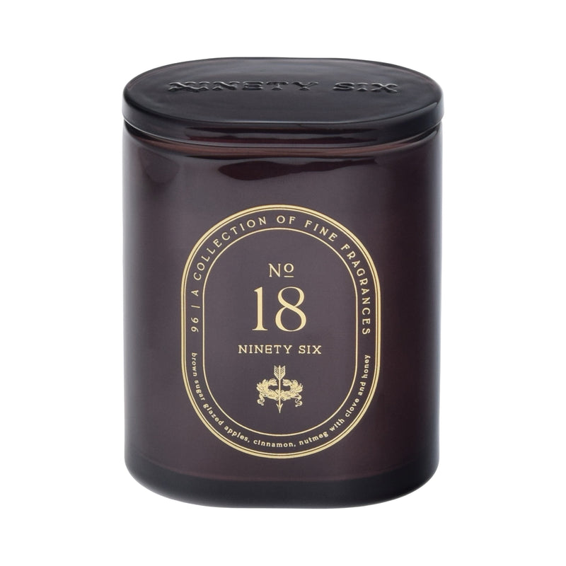 Dark maroon candle with gold text on a maroon background