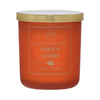 Orange candle with gold lid labeled 'Pumpkin Churro' on a white background