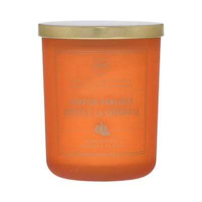 Orange candle with a gold lid on a white background