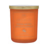 Orange candle with a gold lid on a white background