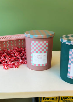 A group of candles filled with DW Home Strawberry Crush candy sit on the table.