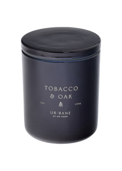 Black candle jar with 'Tobacco & Oak' and brand name on a black background