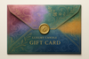 Generate an amazing cool candle company gifting card (envelope) design thumbnail. The envelope should have an elegant but sick/colorful design to represent different candle scents.